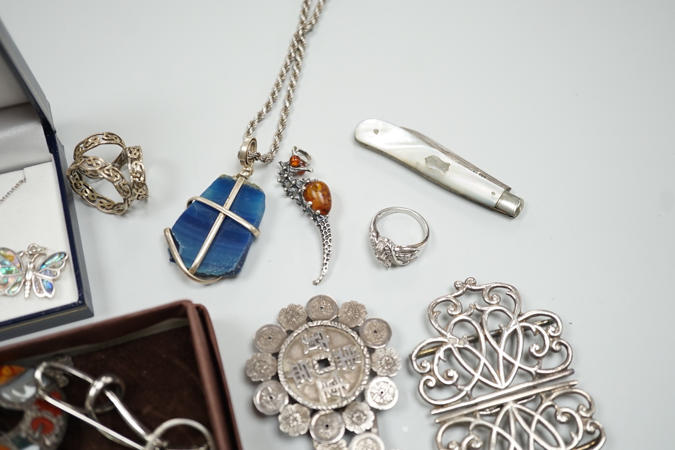 Mixed silver and white metal jewellery including a modern silver nurses buckle, an early 20th century white metal and Scottish hardstone brooch, Chinese white metal buckle by Wang Hing, etc.